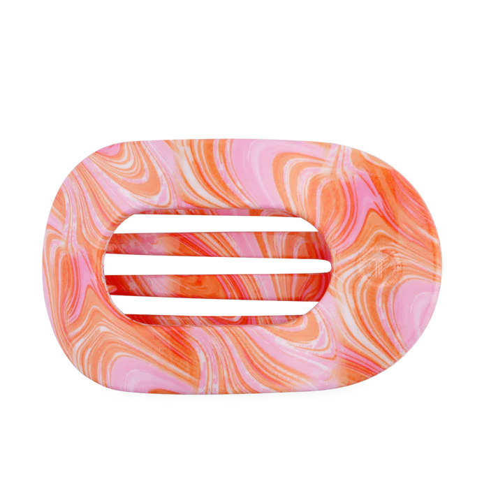Marbled pink and orange hair clip on a white background