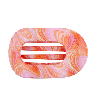 Marbled pink and orange hair clip on a white background