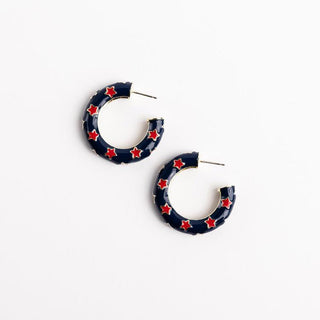 Navy hoop earrings with red star patterns on a white background