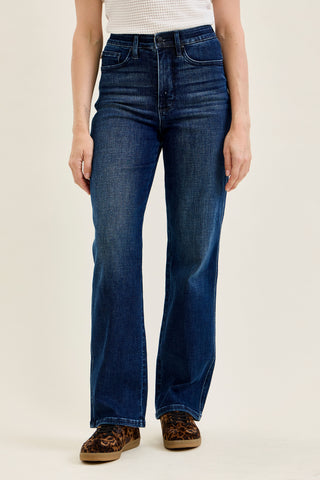 woman wearing dark blue straight leg jeans