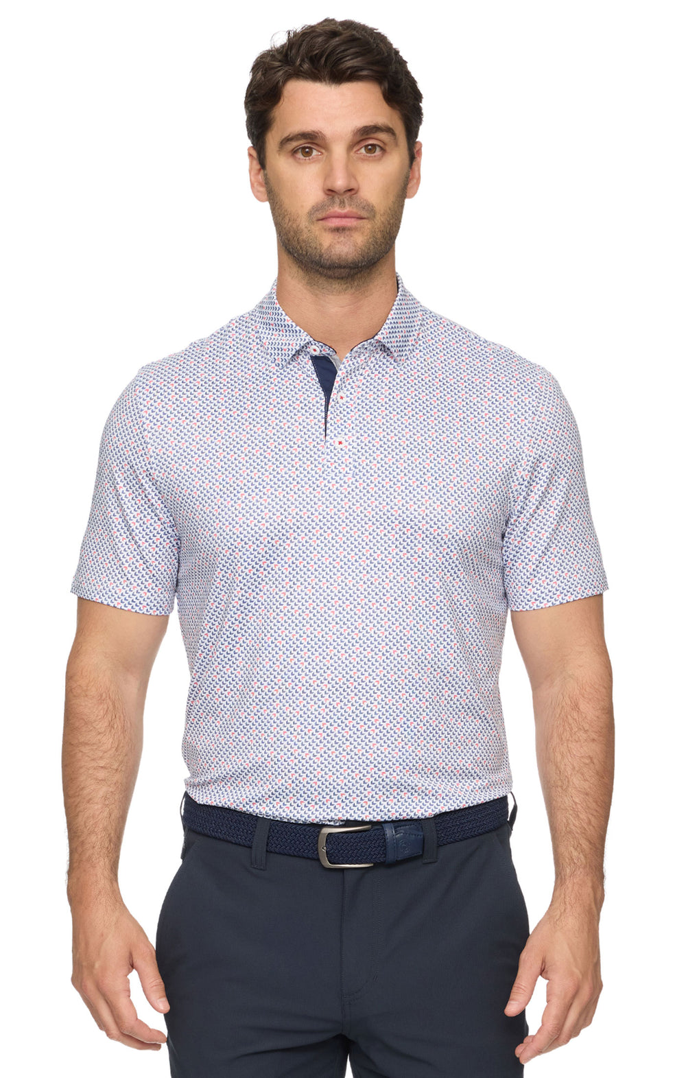Man wearing a patterned short-sleeve shirt and navy pants on a white background
