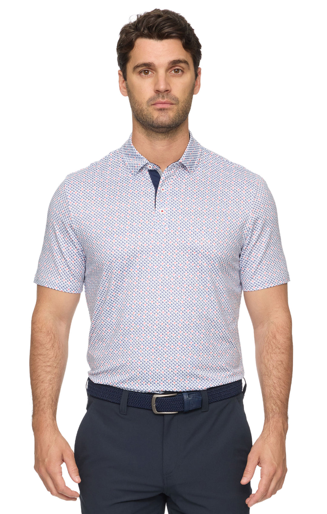 Man wearing a patterned short-sleeve shirt and navy pants on a white background