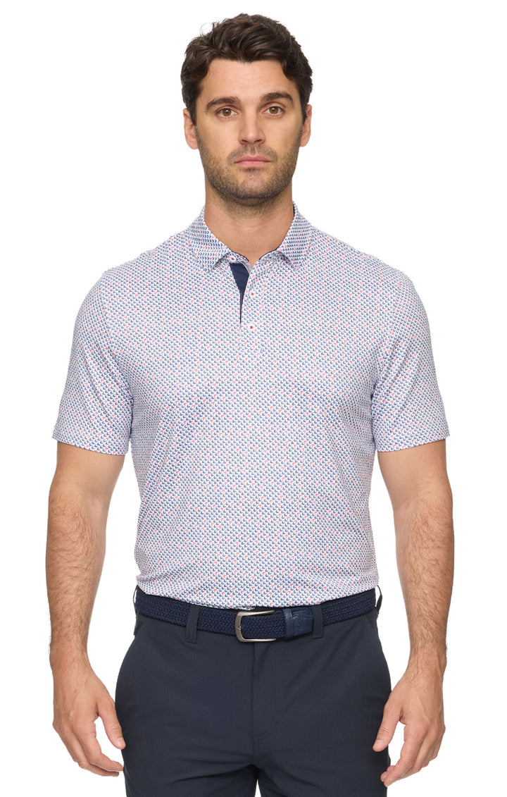 Man wearing a patterned short-sleeve shirt and navy pants on a white background