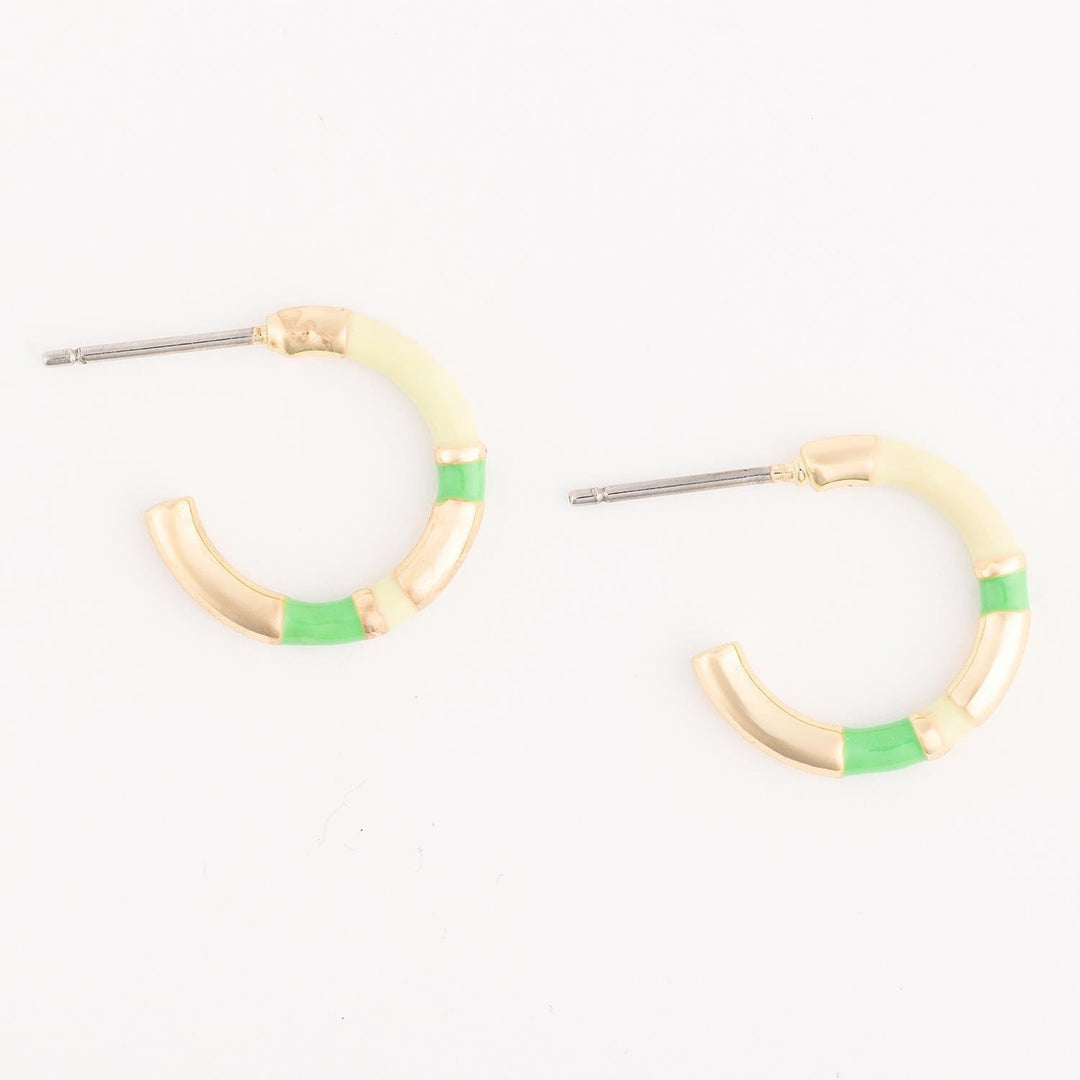 Pair of hoop earrings with green accents on a white background
