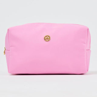 Pink cosmetic bag with a gold logo on a light gray background