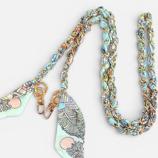 Multicolored braided lanyard with decorative ends on a white background