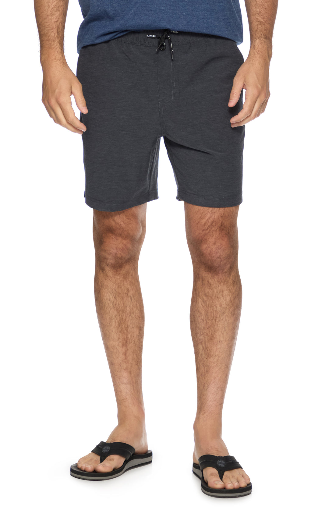 Person wearing dark gray shorts on a white background