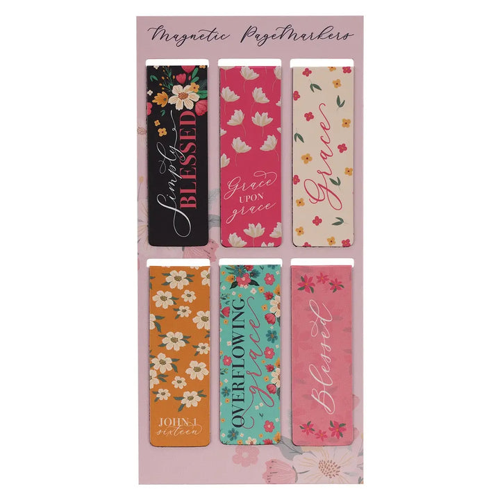 Set of magnetic page markers with floral and inspirational designs on a pink background