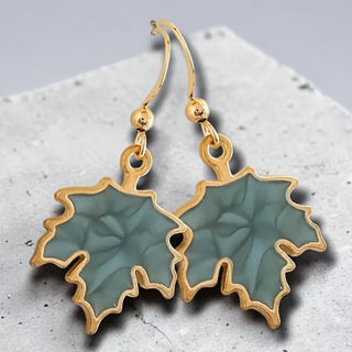Sage green maple leaf earrings with gold accents
