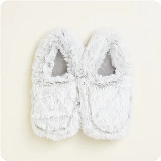plush gray fluffy slippers on a cream backlground