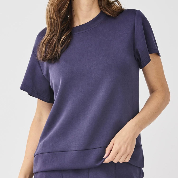 Person wearing a Navy Blue t-shirt on a plain background