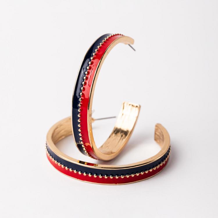 Pair of hoop earrings with red, blue, and gold design on a white background