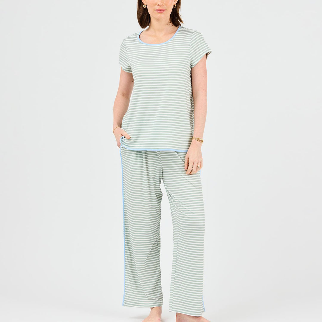 Woman wearing a striped pajama set on a white background