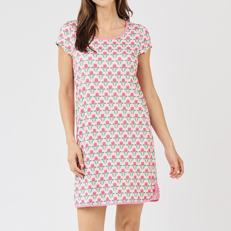 Woman wearing a pink floral nightshirt on a white background