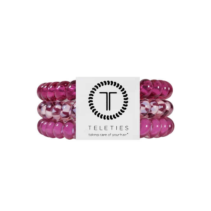 Three pink translucent beaded hair extension bands wrapped together with a white Teleties brand label, shown on a plain white background.
