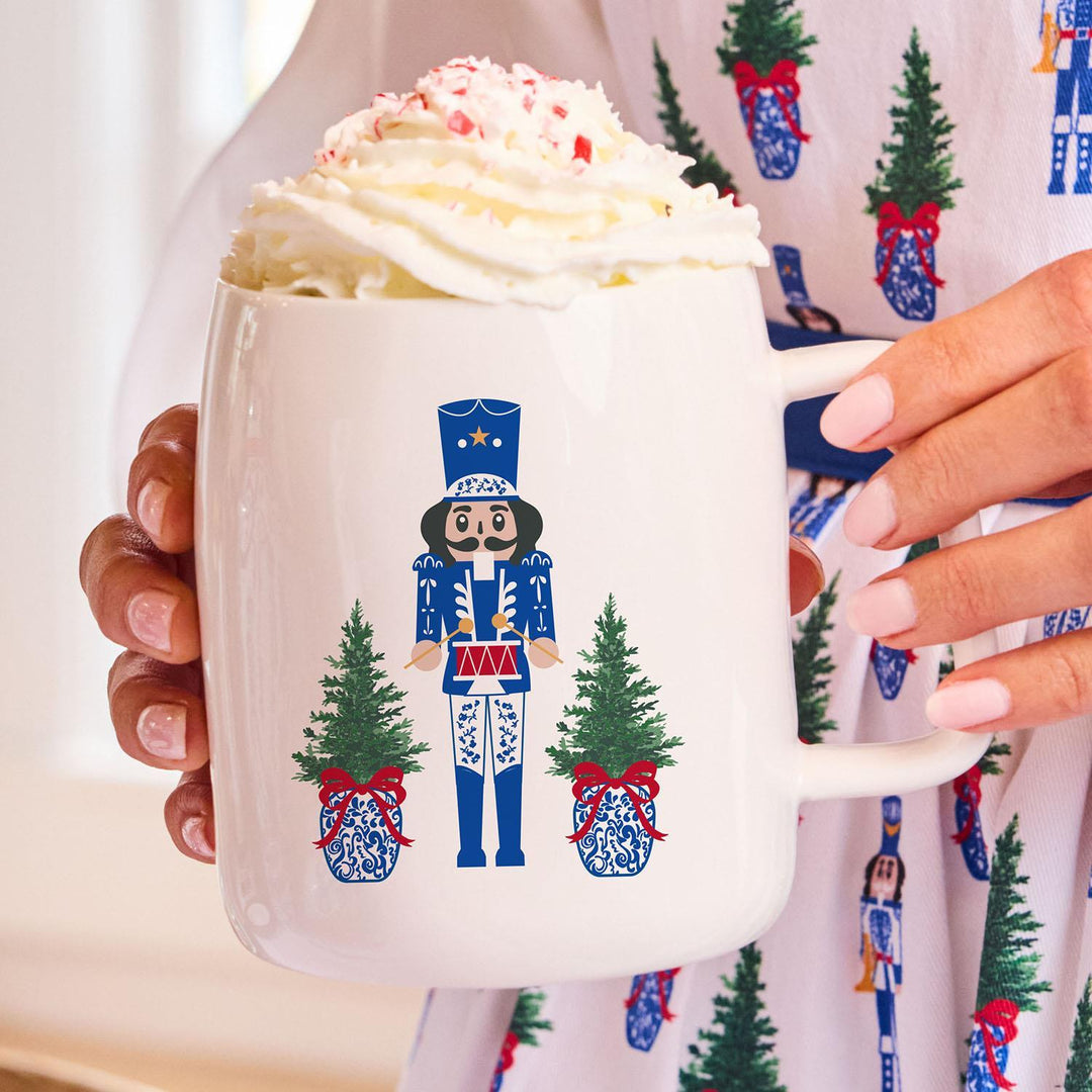 Mug with Nutcracker design holding hot chocolate