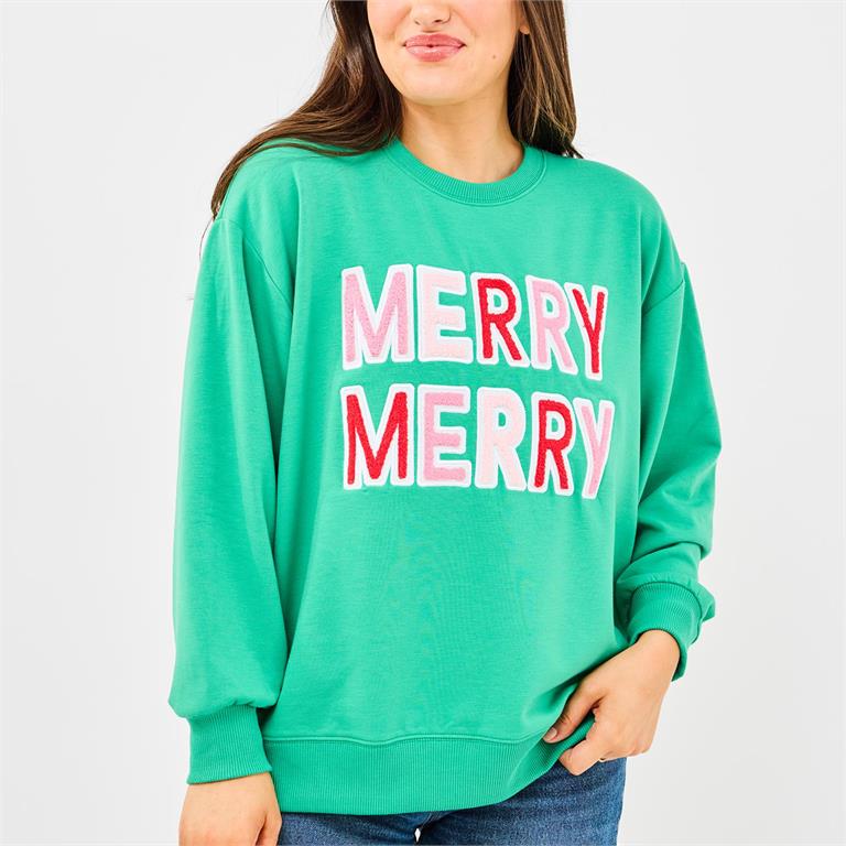 Person wearing a green sweatshirt with 'MERRY MERRY' text on a plain background