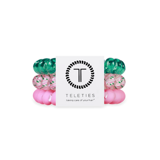 Set of green and pink hair ties with Teleties packaging on a white background