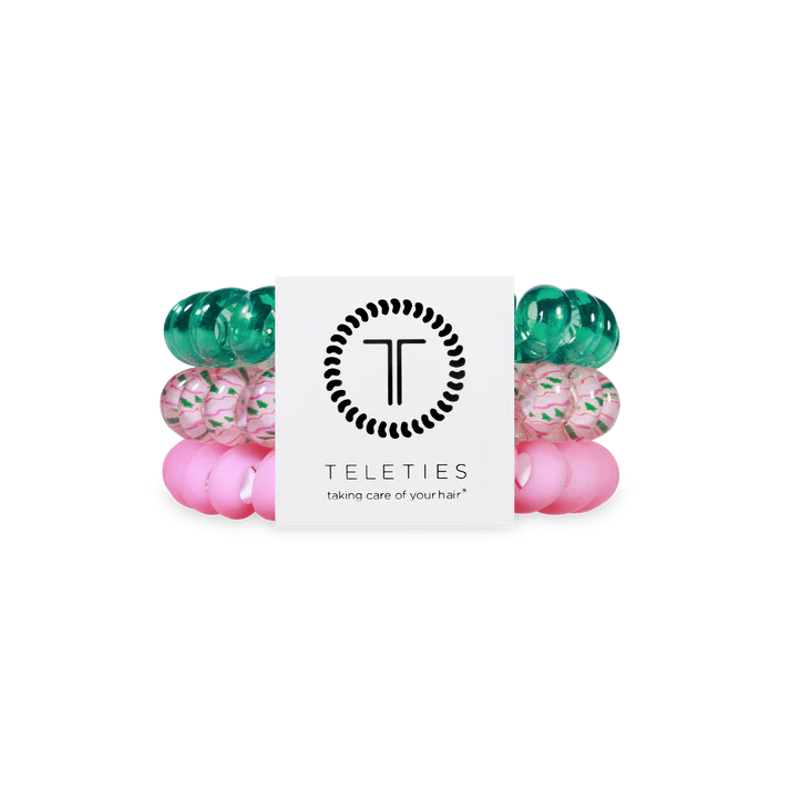 Set of green and pink hair ties with Teleties packaging on a white background
