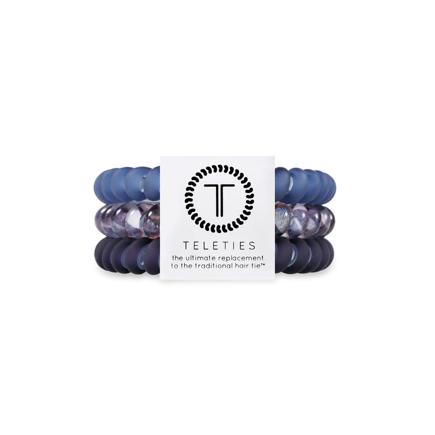 Set of blue hair ties with a Teleties branded card on a white background