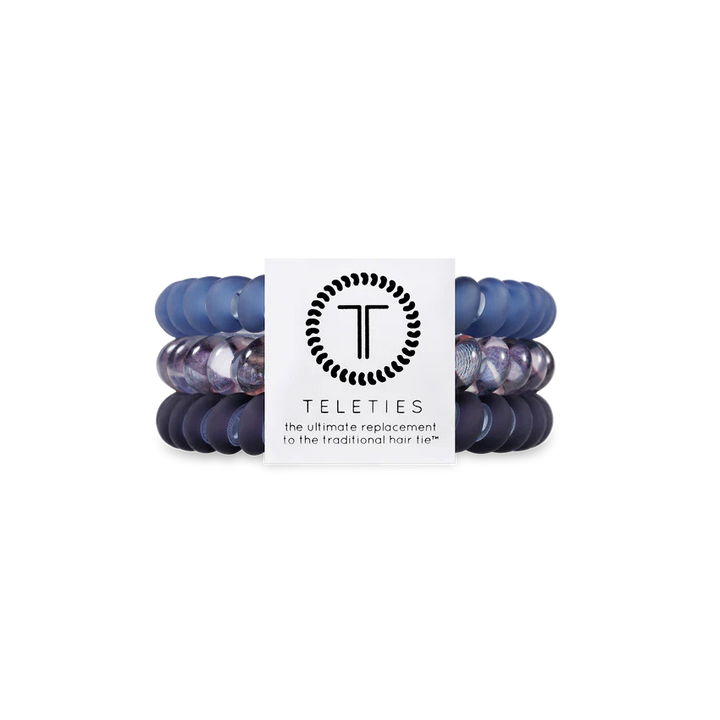 Set of blue hair ties with a Teleties branded card on a white background