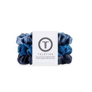 Set of blue scrunchies with a Teleties branded card on a white background