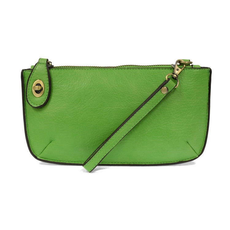 Green handbag with a strap on a white background