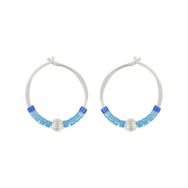 Pair of hoop earrings with blue and silver beads on a white background