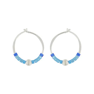 Pair of hoop earrings with blue and silver beads on a white background