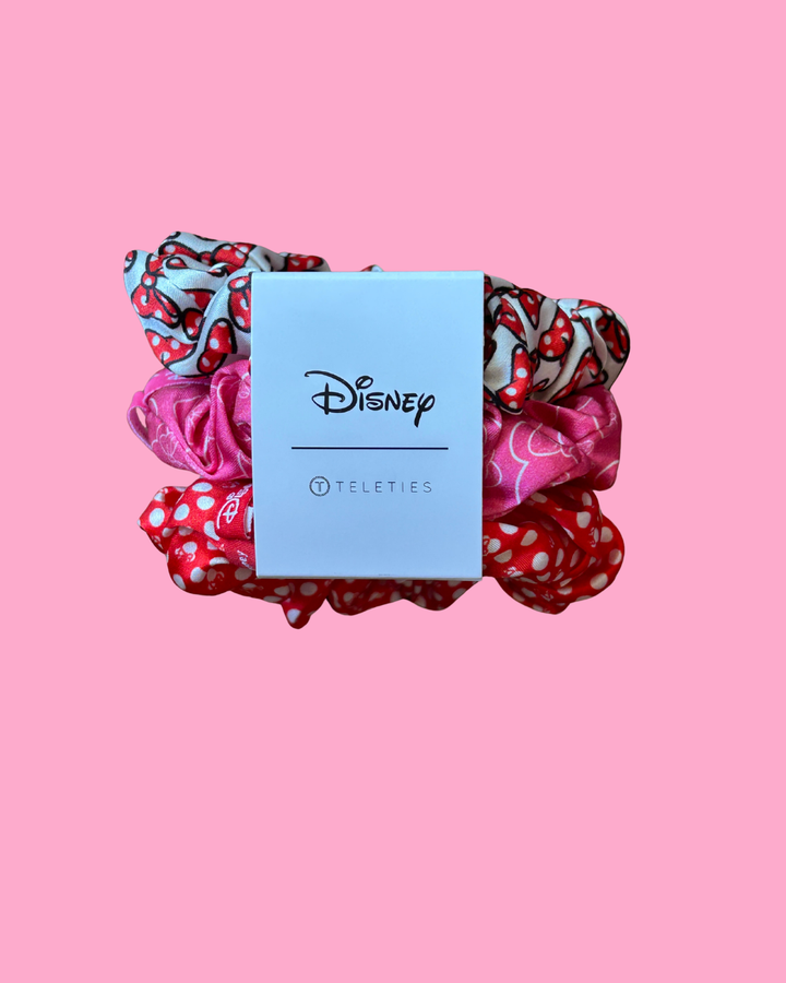 Set of colorful scrunchies with a Disney Teleties card on a pink background