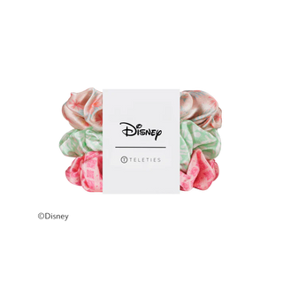A set of four Disney Teleties scrunchies in pastel colors, wrapped in a white paper band featuring the Disney logo.