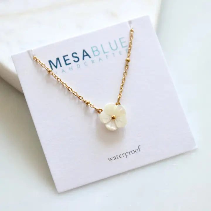 Necklace with a floral pendant on a Mesa Blue card