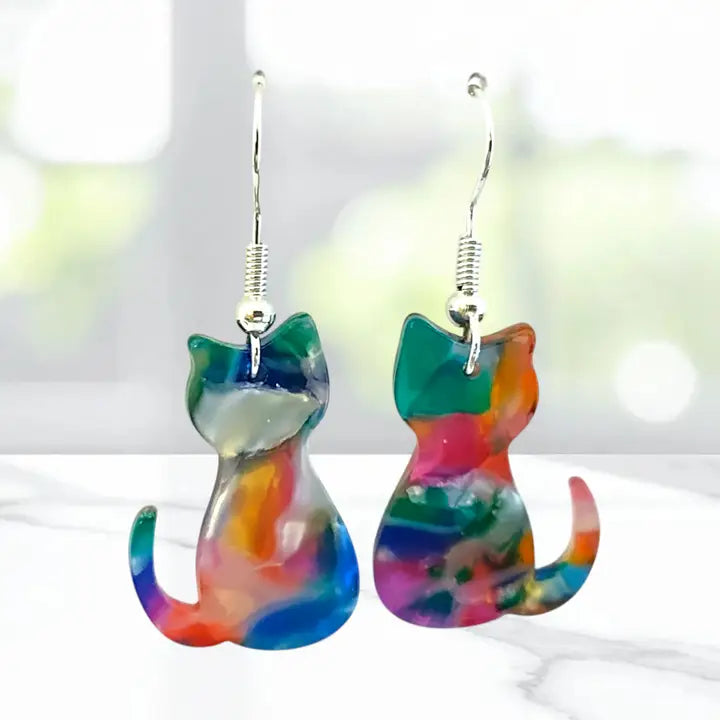 Colorful cat-shaped earrings on a white background