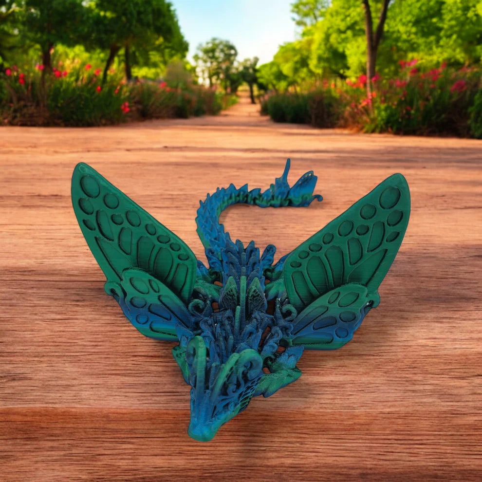 Blue and green dragon-like creature toy on a wooden surface with a natural background