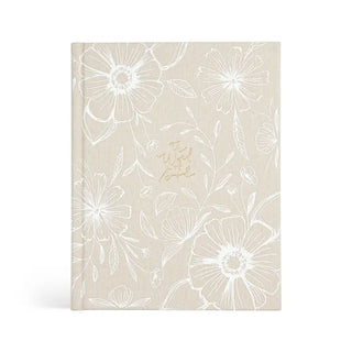 Beige notebook with white floral pattern on a white background