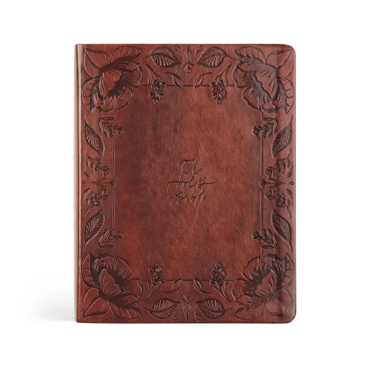Brown leather notebook with floral embossing on a white background