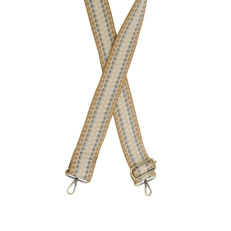 Beige and brown striped bag strap with metal clasps on a white background