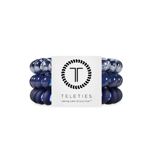 Set of blue hair ties with a Teleties branded card on a white background