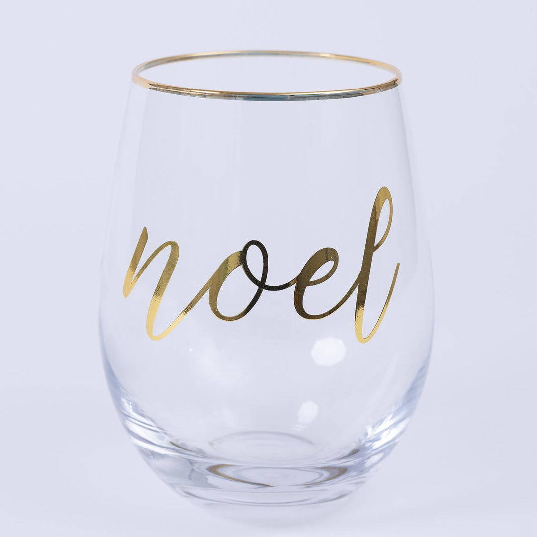 Clear glass with 'noel' in gold on a light gray background