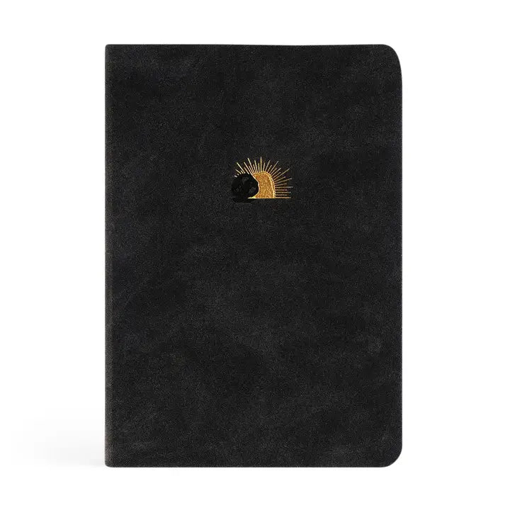 Black notebook with a gold and black design on a white background