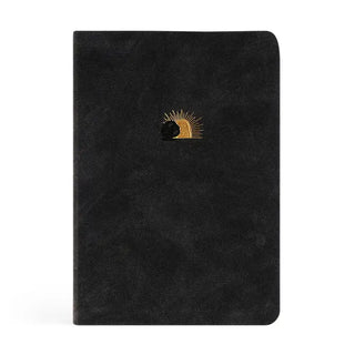 Black notebook with a gold and black design on a white background