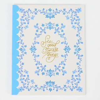 Decorative card with blue floral border and gold text on a white background