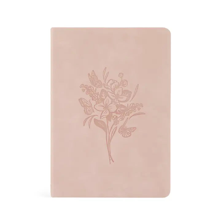 Blush pink notebook with floral design on a white background