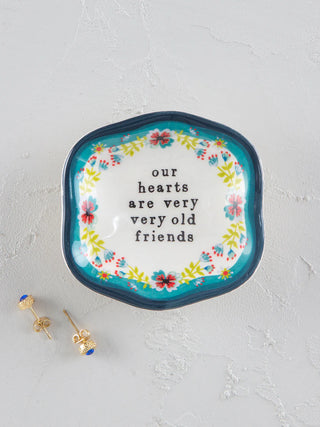 Decorative plate with floral border and text on a light gray background