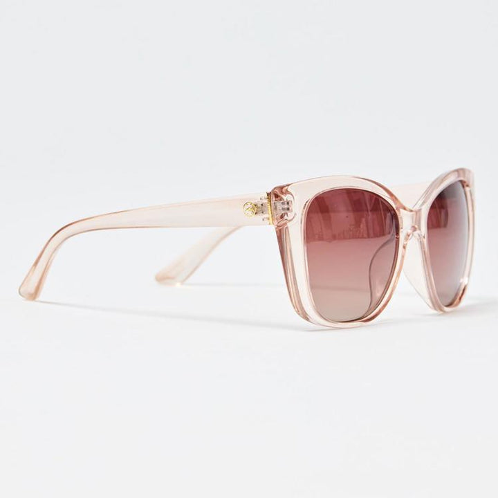 Sunglasses with pink frame and brown lenses on a light gray background