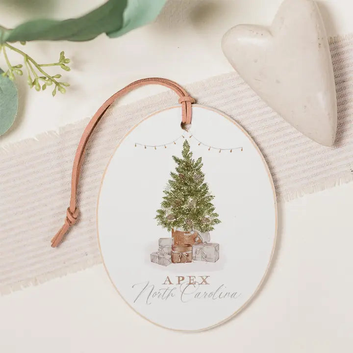 Decorative ornament with a Christmas tree and presents design, featuring the text 'Apex North Carolina'.