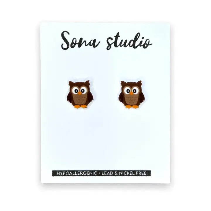 Owl-shaped earrings on a card with 'Sona Studio' branding