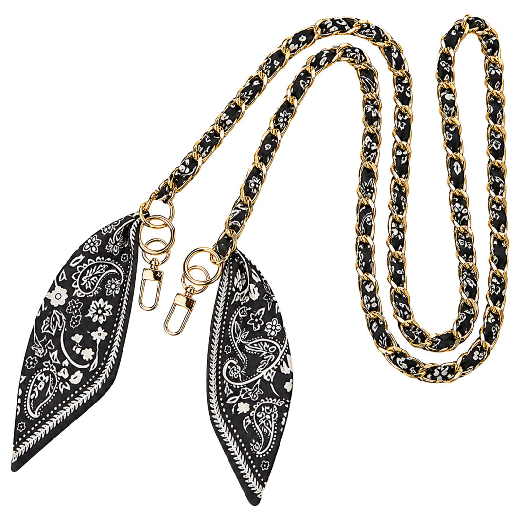 A black and white paisley-patterned chain strap with gold-tone hardware, featuring two matching decorative end pieces on a plain white background.
