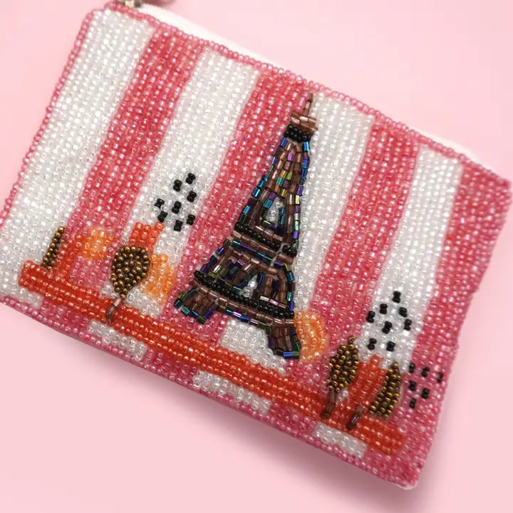 Beaded clutch with Eiffel Tower design on a pink background