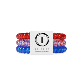 Set of red, white, and blue hair ties with Teleties logo in the center on a white background